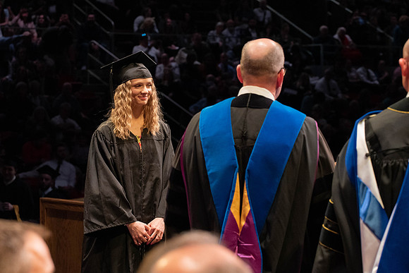 Students graduate and walk to receive their diplomas during convocation in the College of Physical Sciences and Engineering.