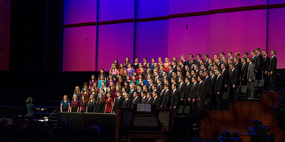The combined Men's and Women's Choir performs "We Walk by Faith" during Commencement.