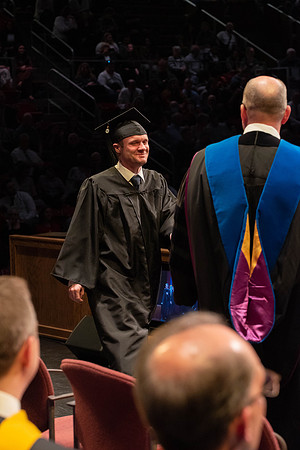 Students graduate and walk to receive their diplomas during convocation in the College of Physical Sciences and Engineering.
