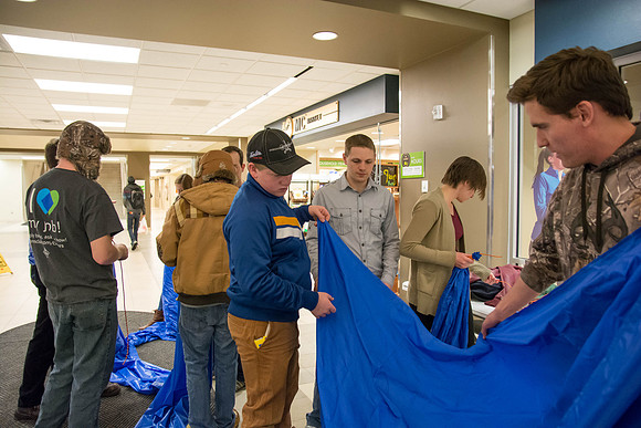 Students learn to make hammocks out of parachute material.