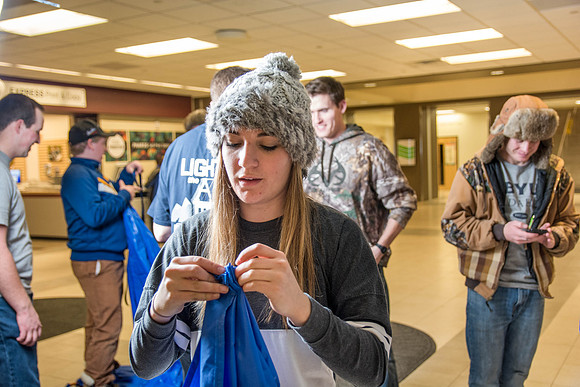 Students learn to make hammocks out of parachute material.