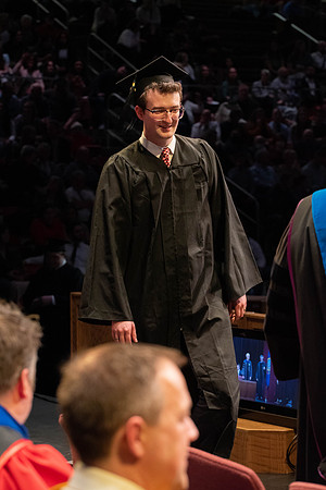 Students graduate and walk to receive their diplomas during convocation in the College of Physical Sciences and Engineering.