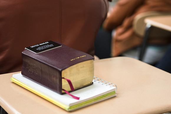 Student brings scriptures used from serving a mission in a religion class.