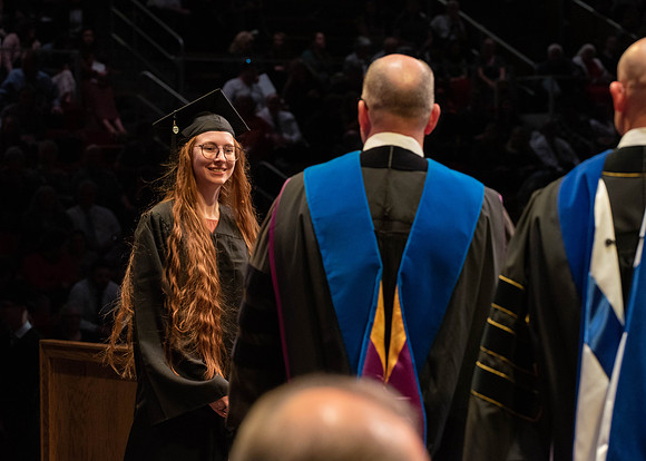 Students graduate and walk to receive their diplomas during convocation in the College of Physical Sciences and Engineering.