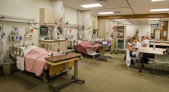 Nursing students work with their instructor in the John L. Clarke Nursing Lab.