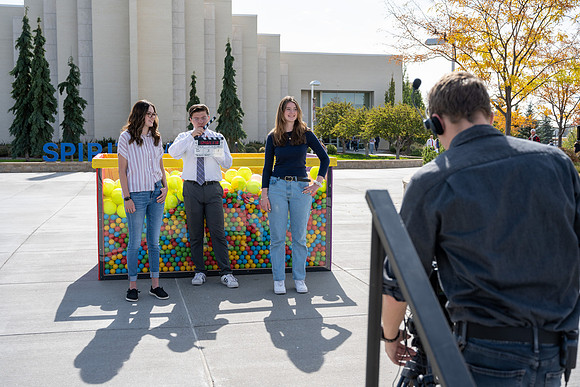 Students who volunteer to participate sit in the ball pit and ask each other questions which are found on the balloons. Video is being produced for Student Living.