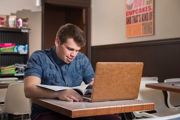 Blake Jensen studies for an Online class at the Cocoa Bean Cafe in Rexburg, ID.