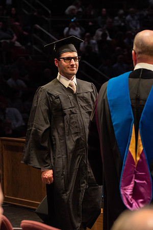 Students graduate and walk to receive their diplomas during convocation in the College of Physical Sciences and Engineering.