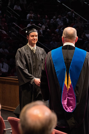 Students graduate and walk to receive their diplomas during convocation in the College of Physical Sciences and Engineering.