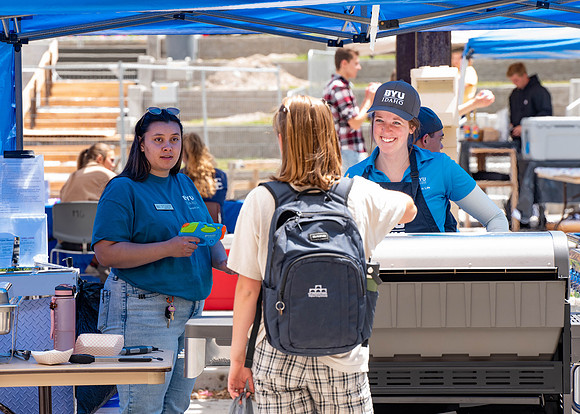 Students get free hot dogs, and enjoy activities at the Amphitheatre. IBC Business sell their products.