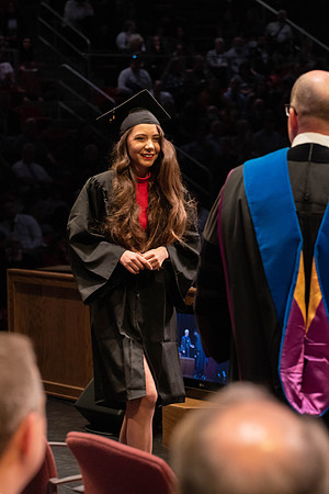 Students graduate and walk to receive their diplomas during convocation in the College of Physical Sciences and Engineering.