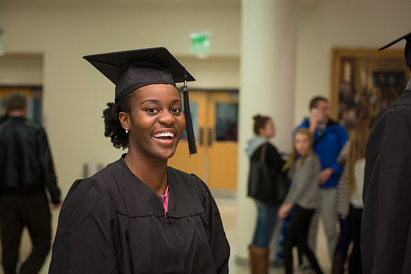A graduate smiles after the ceremony in the I-Center.