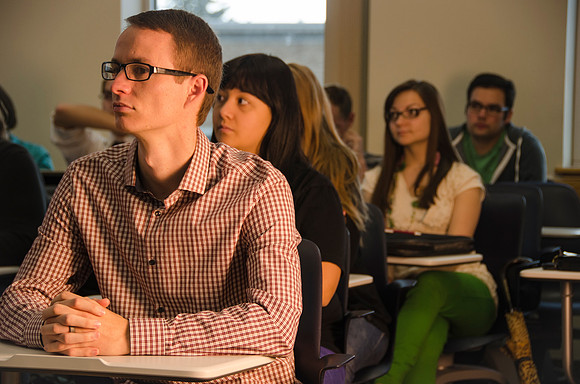 Student listening as Robyn Bergstrom instructs a Group Dynamics class
