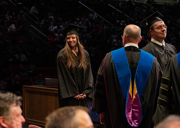Students graduate and walk to receive their diplomas during convocation in the College of Physical Sciences and Engineering.