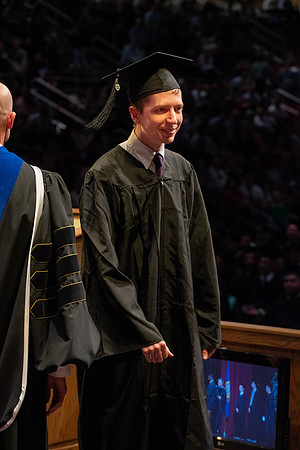 Students graduate and walk to receive their diplomas during convocation in the College of Physical Sciences and Engineering.