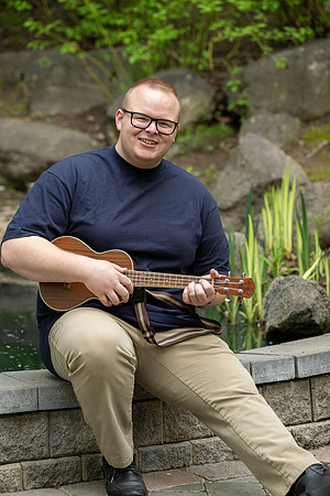 Thommy Oaks enjoying a little freetime in the gardens while playing the ukulele.