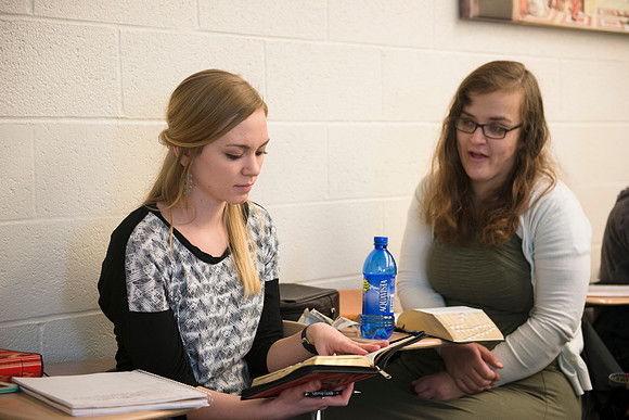 Students help and teach one another in Brother Peterson's religion class.