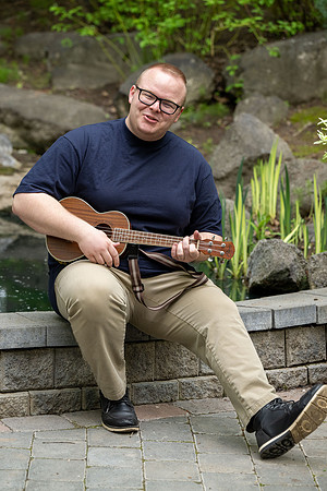 Thommy Oaks enjoying a little freetime in the gardens while playing the ukulele.