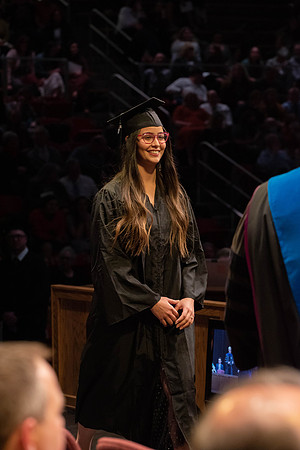 Students graduate and walk to receive their diplomas during convocation in the College of Physical Sciences and Engineering.