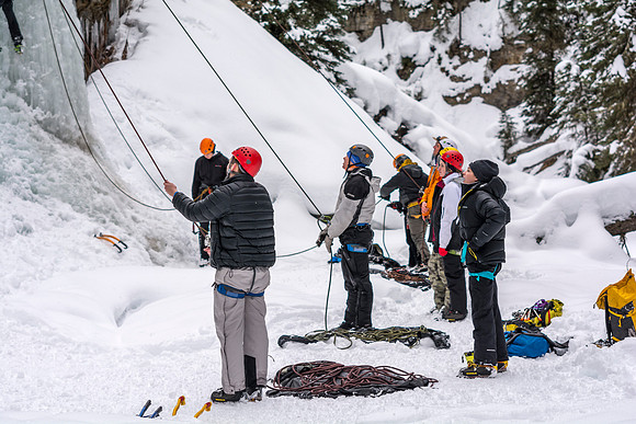 Students belaying other students ice climbing.
