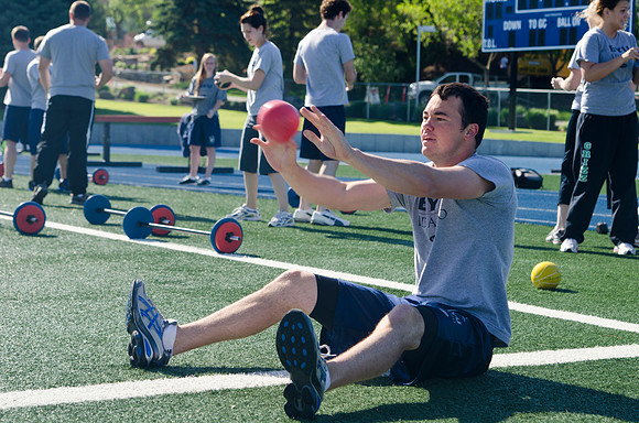 A cross-weight training class takes advantage of some beautiful weather to train in the Hart Stadium.