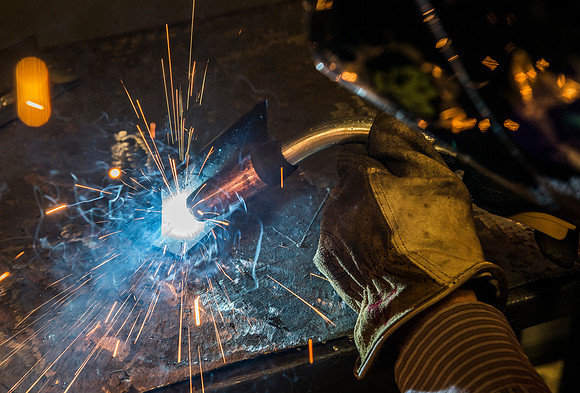 Clay Rasmussen, from the Mechanical Engineering Department, welds during a demonstration.