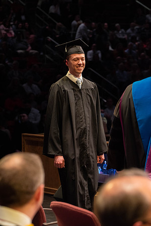 Students graduate and walk to receive their diplomas during convocation in the College of Physical Sciences and Engineering.