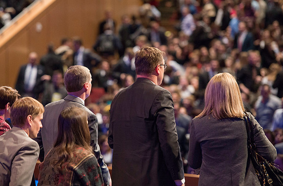 President Gilbert and Elder Bednar look out to the audience at the end of devotional.