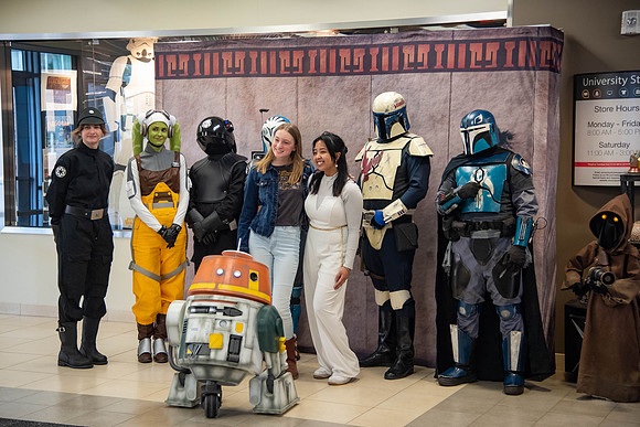 Students celebrate May the 4th be with you day, taking pictures with students in cosplay.