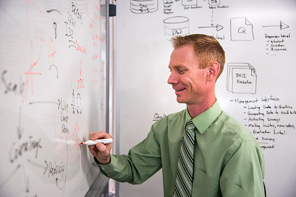Employees work on developing a better curriculum for online students.