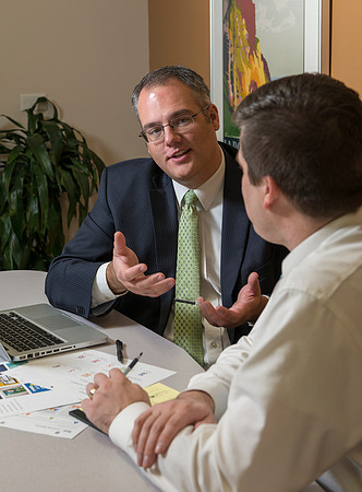 Arnold Thiebaud, Creative Services manager and Director of Marketing Communciations discusses a project with Jed Rhein the MarComm Graphic Designer.