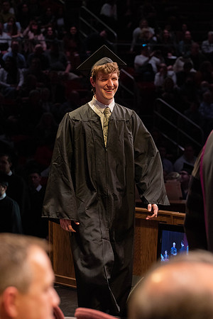 Students graduate and walk to receive their diplomas during convocation in the College of Physical Sciences and Engineering.