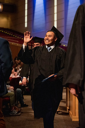 Students graduate and walk to recieve their diplomas during convocation in the College of Business and Communications.