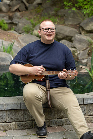 Thommy Oaks enjoying a little freetime in the gardens while playing the ukulele.