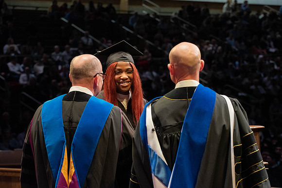 Students graduate and walk to receive their diplomas during convocation in the College of Physical Sciences and Engineering.