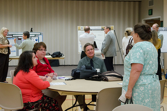 Faculty members talking together at the faculty meeting Fall 2013