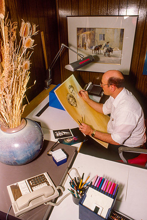Graphic Artist, Dick Bird, works on an original piece. Illustration for President Joe J. Christensen.