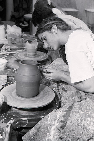 Art student works diligently on a piece of pottery for Ceramics class.