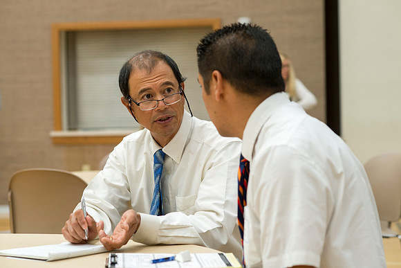 Faculty gather in the Hinckley Building at a Faculty Conference to share and learn from each other at the beginning of the 2013 Fall semester.