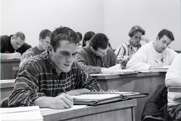 Business teacher, Phillip Packer teaches students in the classroom. December 1995.