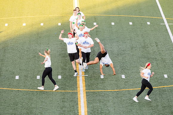 Students gather at the stadium to watch the football championship.