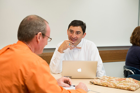Faculty gather in the Hinckley Building at a Faculty Conference to share and learn from each other at the beginning of the 2013 Fall semester.
