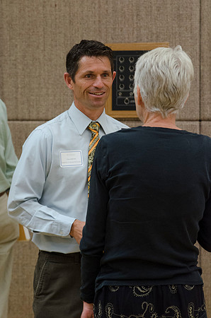 Faculty members talking together at the faculty meeting Fall 2013