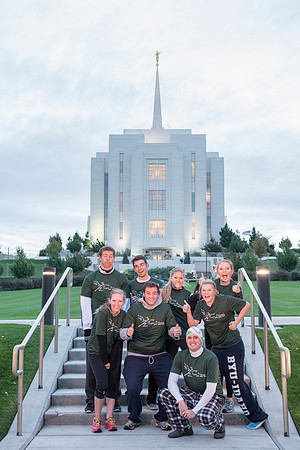 Team members pose by the Rexburg temple before they begin the temple to temple run