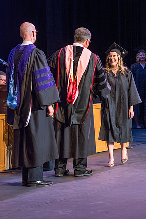 BYU-Idaho graduates accepting their diploma covers at convocation for the College of Perfoming and Visual Arts. Photo by Ryan Chase