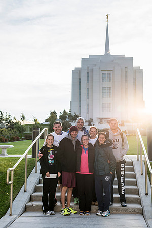 Team members pose by the Rexburg temple before they begin the temple to temple run