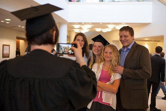 Graduates gather inside the I-Center to take pictures before Commencement.
