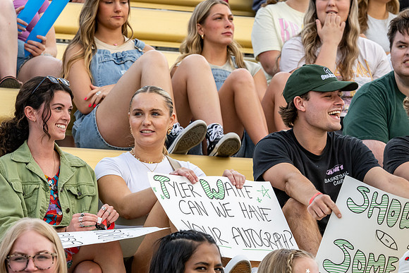 Students gather at the stadium to watch the football championship.