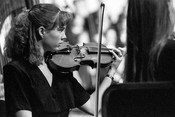 Member of the orchestra playing a piece