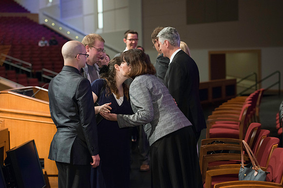 Bishop Gérald Caussé and his wife greet students after devotional.